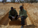 	Isaac and Headteacher, Sana Tembeley, showing work on foundations for new classrooms.