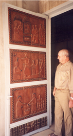 Pére Yves showing the carved door at Pel Catholic Mission